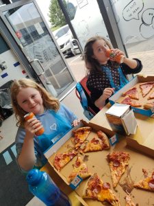 2 children eating pizza